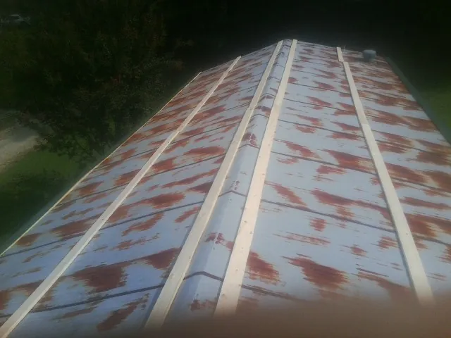Rusted metal roof panels with new wood purlins before replacement — Storm Damage Roof Repair in Clark Mills by Roofing Brothers